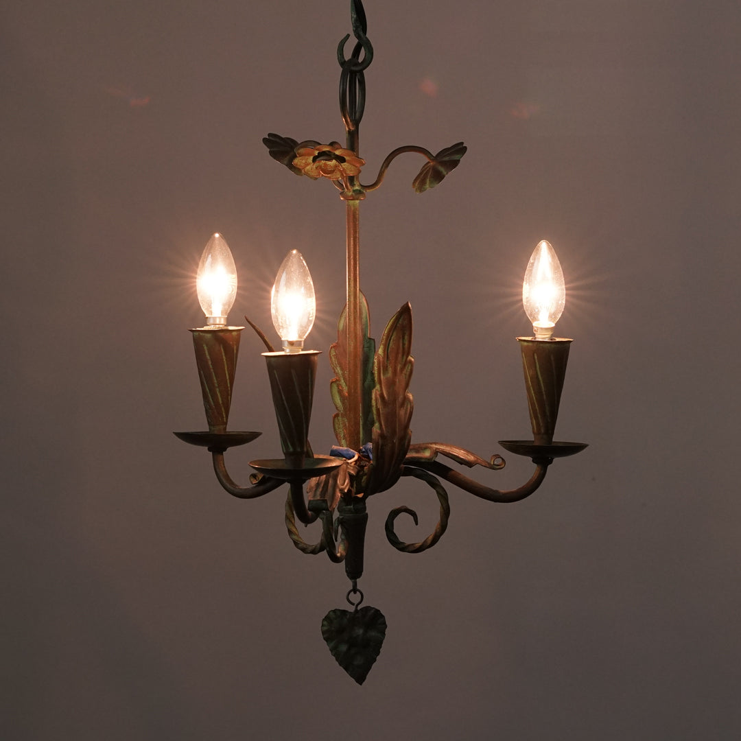Wrought iron ceiling lamp with flower detailing. There are three lights.