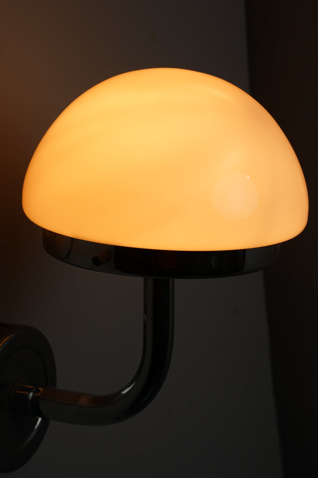 Three similar lamps with chromed metal frame and cloudy white glass dome.