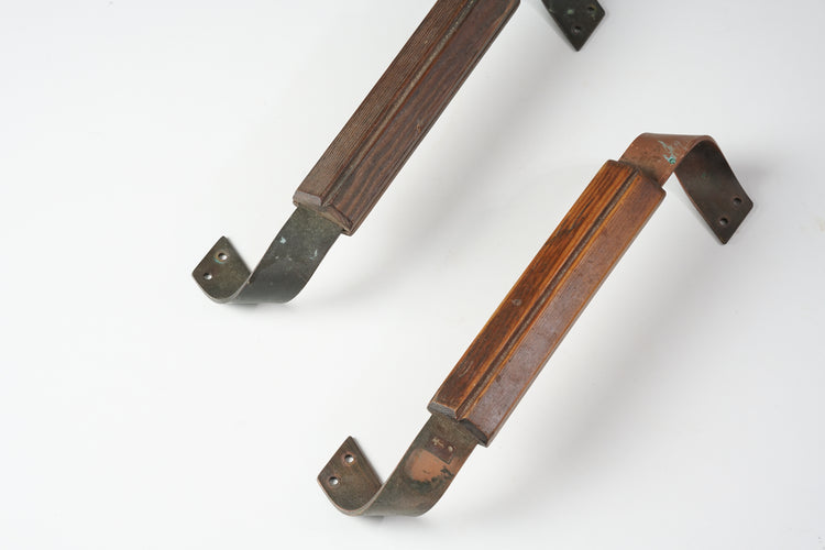 Two door handles made of pine and copper. The pine has a slight shade difference.