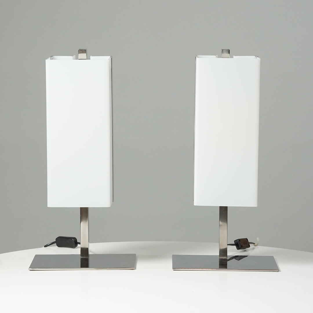 Two identical lamps. The shape of the white acrylic shade is of a rectangle and the base of the lamp is made of metal.