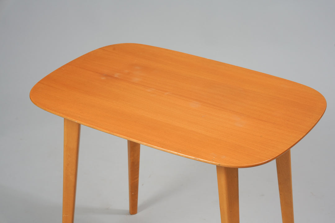 A coffee table made of elm with four legs.