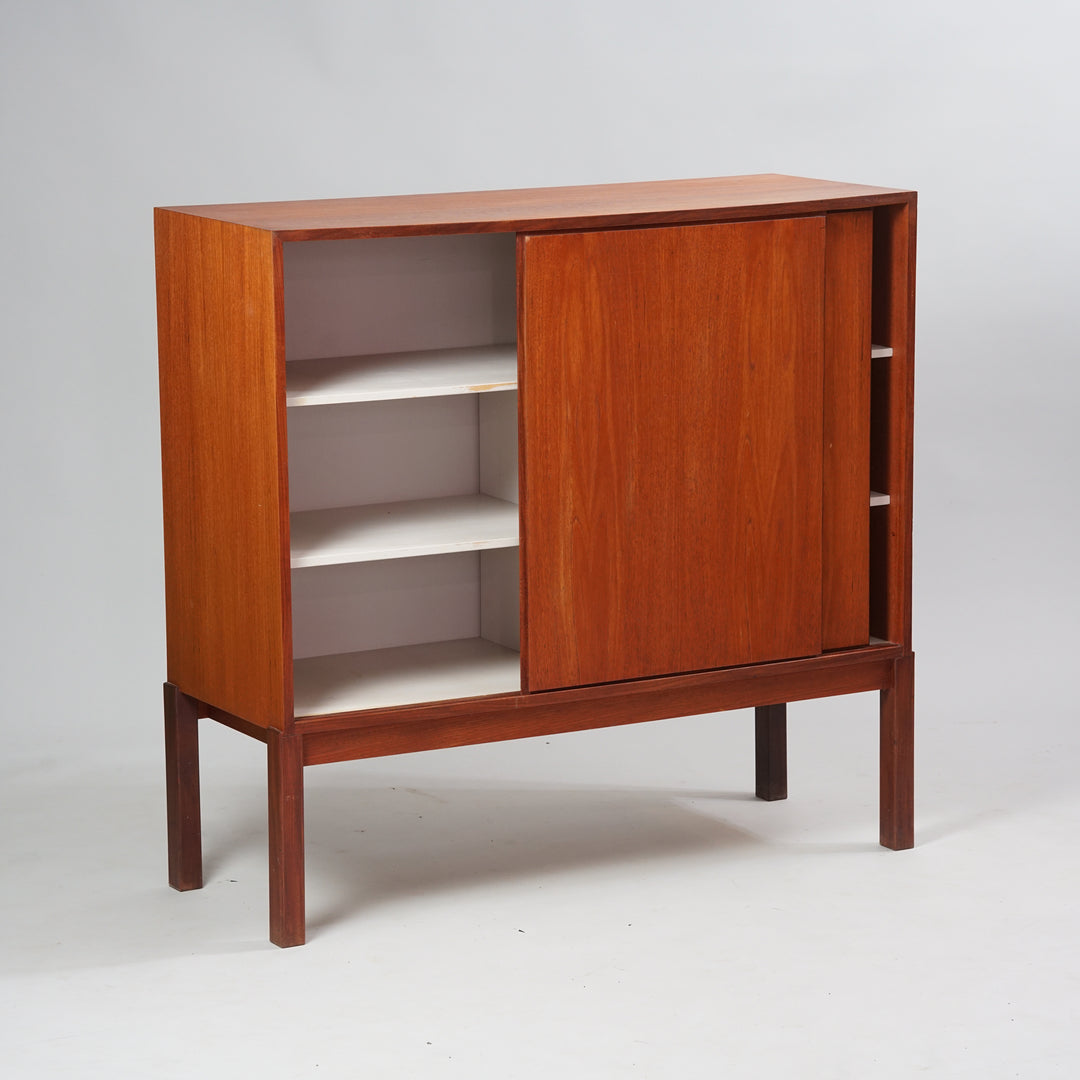 A cabinet made of teak with two sliding doors and four shelves inside.