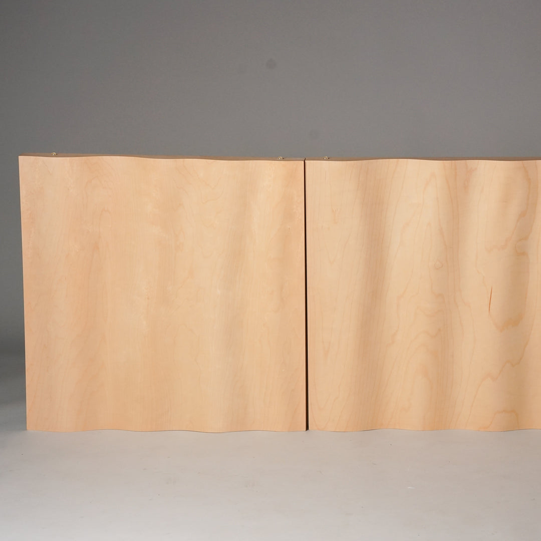 Square shaped wall panel made of birch plywood. The panel is a light wooden color and has a wavy shape.