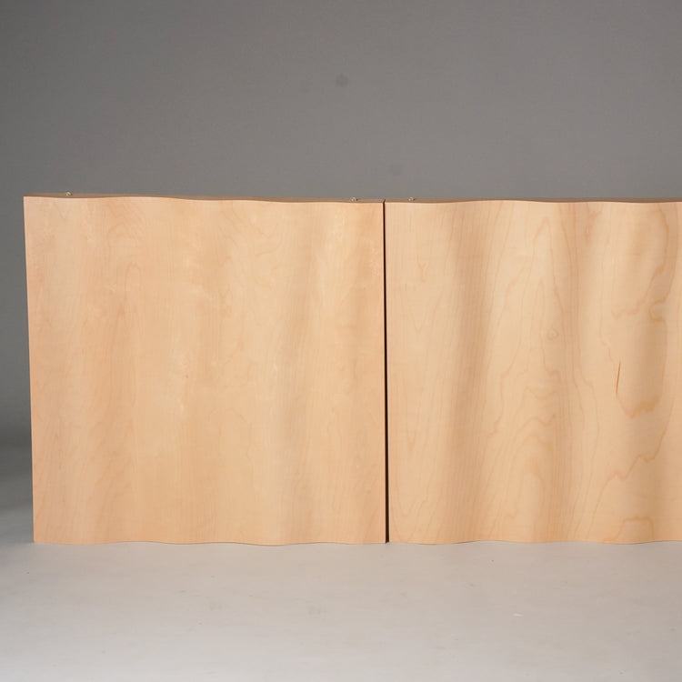 Square shaped wall panel made of birch plywood. The panel is a light wooden color and has a wavy shape.