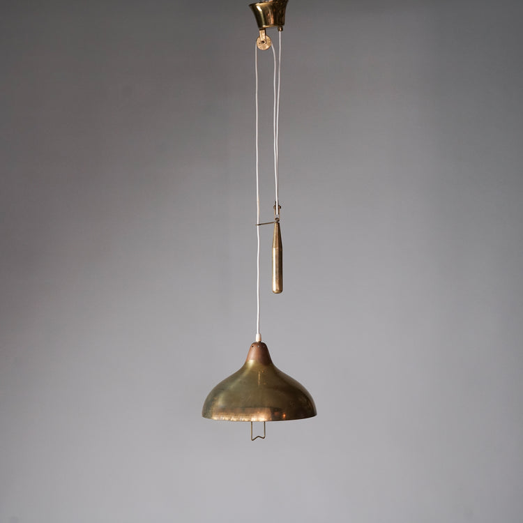 Brass ceiling light with counterweight mechanism. The shade features small three-hole clusters that reflect light and has a handle in the middle.
