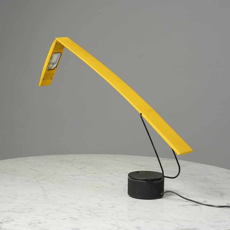 An abstract yellow lamp made of metal and plastic.