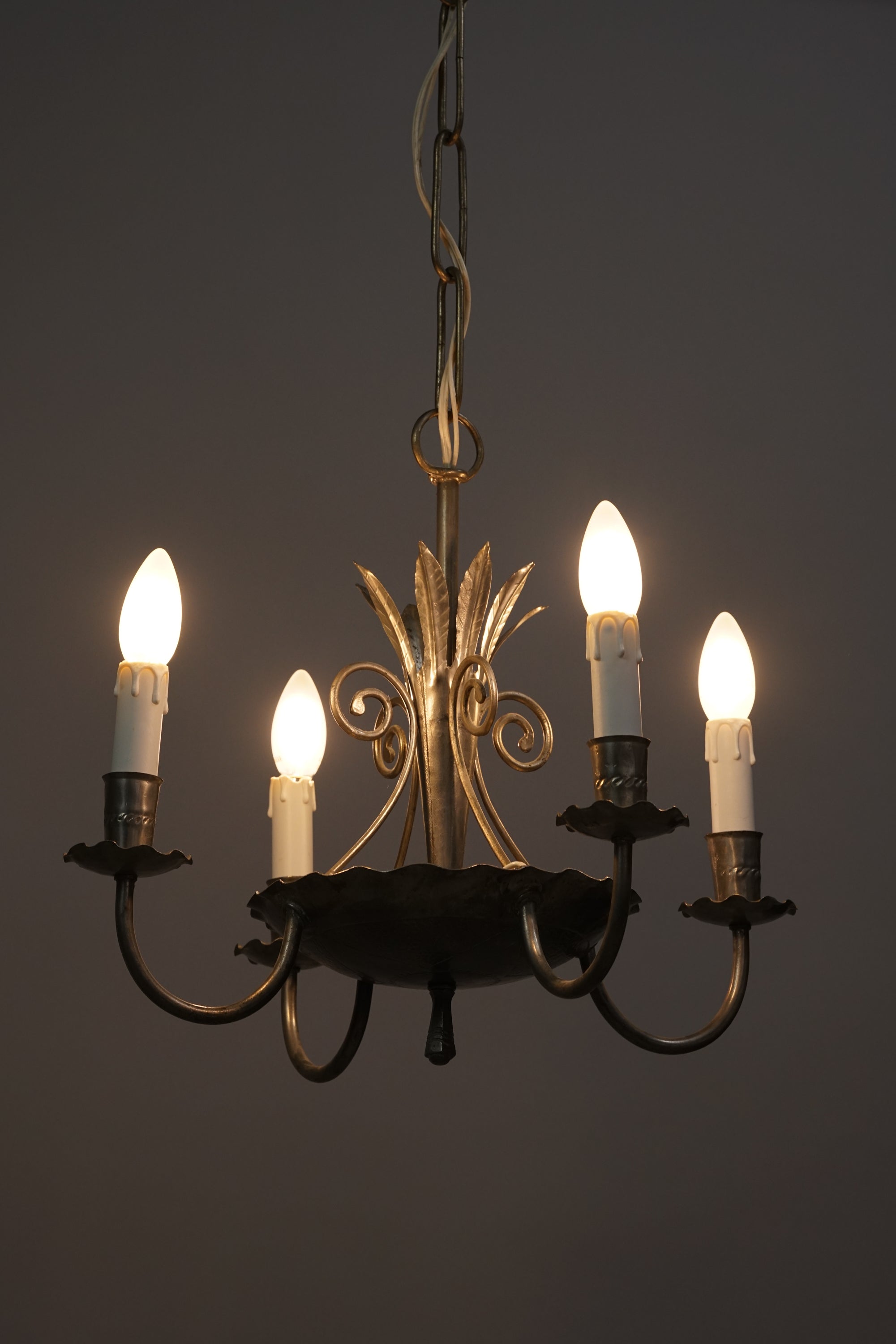 Detailed wrought iron ceiling lamp. Has four holders for lamps or candles.