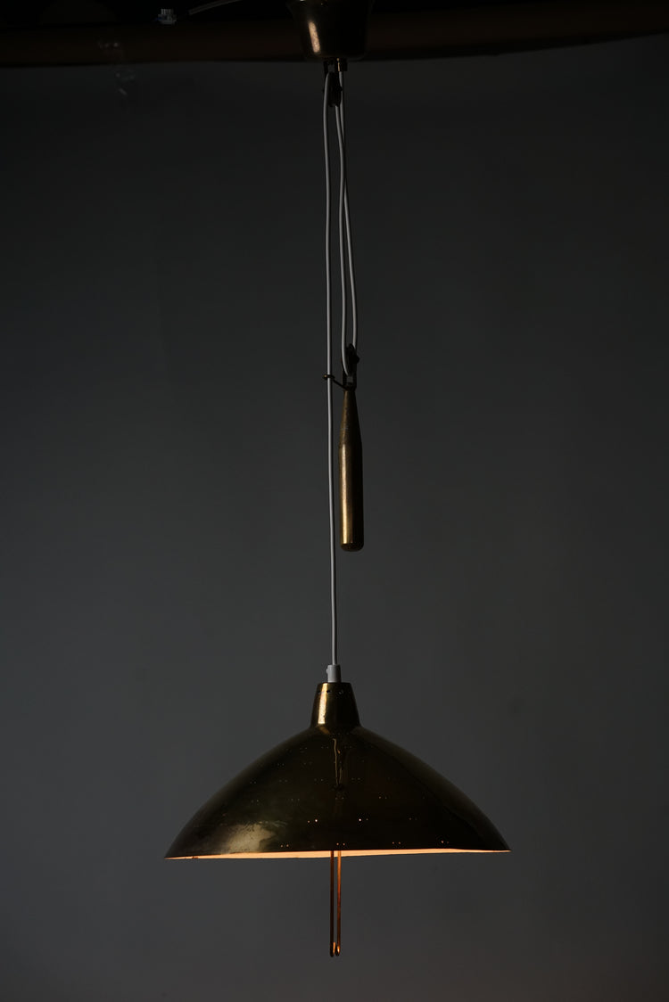 Brass ceiling lamp.The lamp has a counter weight with the possibility to change the height of the lamp. The brass shade has a handle to raise and lower the lamp and small holes to let the light shine out beautifully.