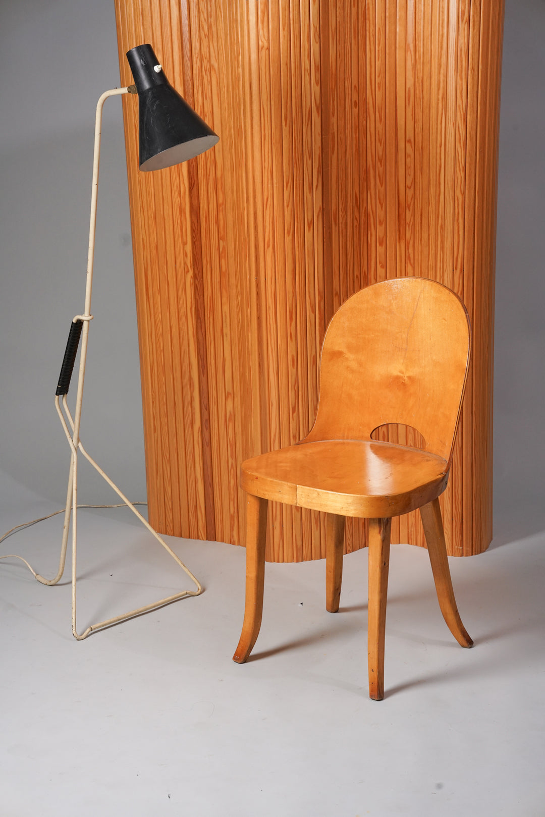 A room divider wall consisting of thin pine beams. Honey brown color. 