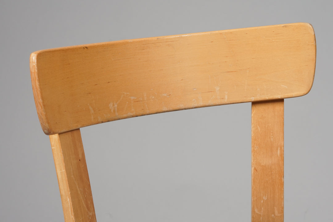 Light birch chair. Four legs. Blue fabric upholstery on the seat. 