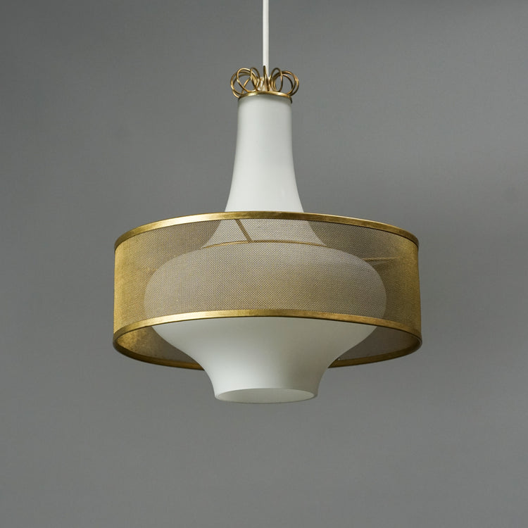 White opal glass lamp which is wider in the middle. The middle part of the lamp has a brass shade and brass details. 