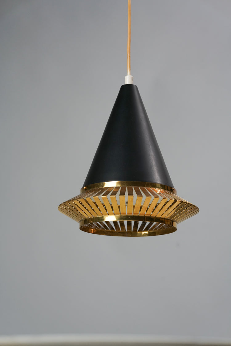 Black painted metal lamp with the bottom being a grid made of brass.