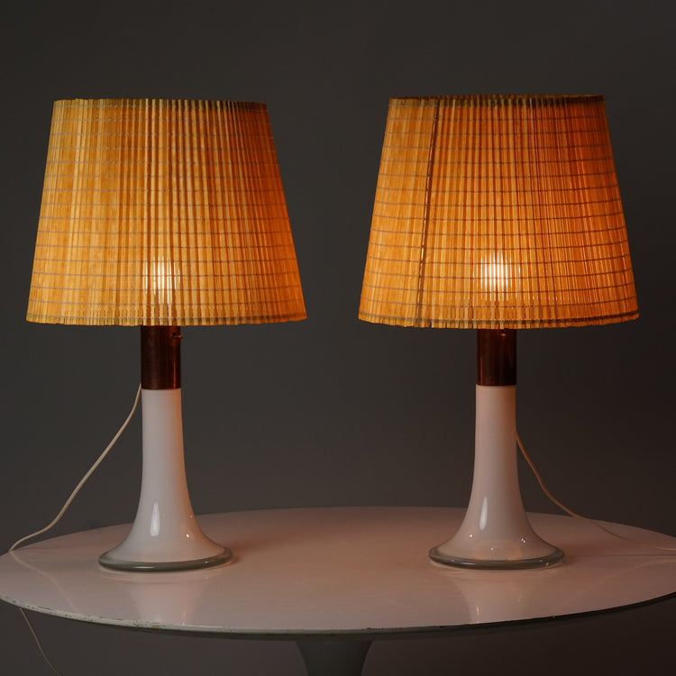 The base of the lamp is opal glass with copper detailing. Shade is made of wood slats.