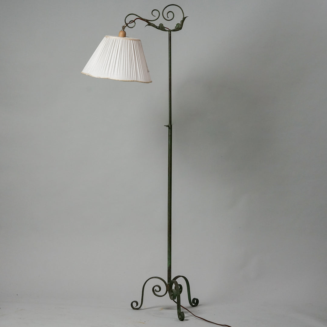 Lamp with wrought iron leg and white shade made of cotton.