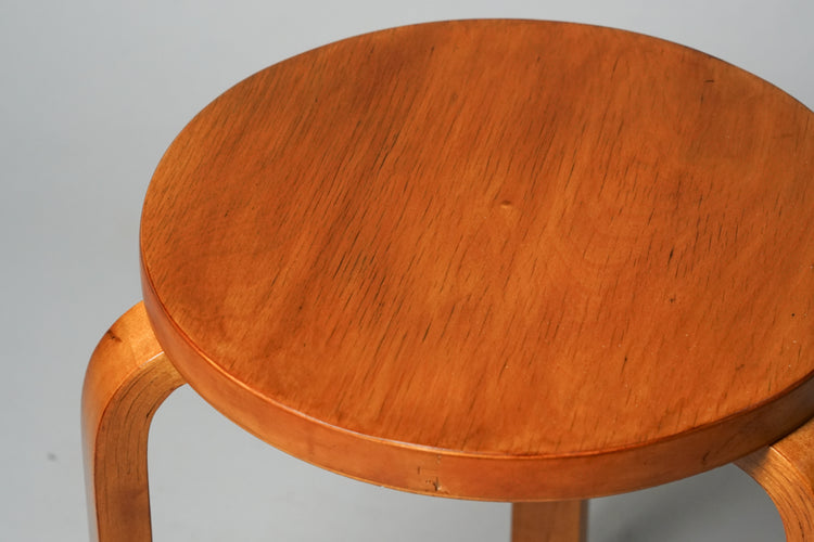 Three legged stool made of birch, The seat is round.