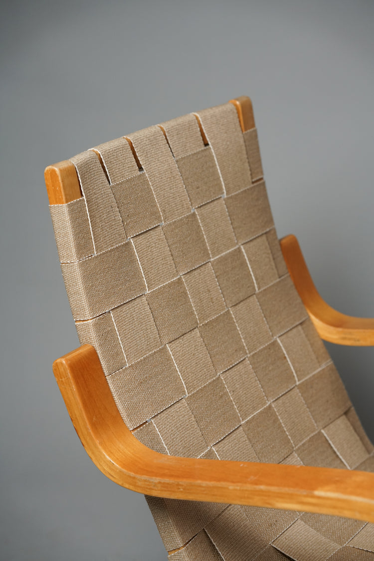  A birch chair with a woven seat and armrests.