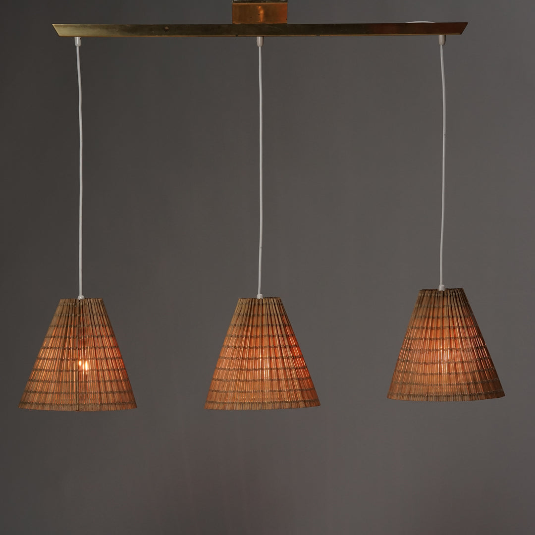 brass base ceiling lamp with three lamps. The lamps have shades made of wood.