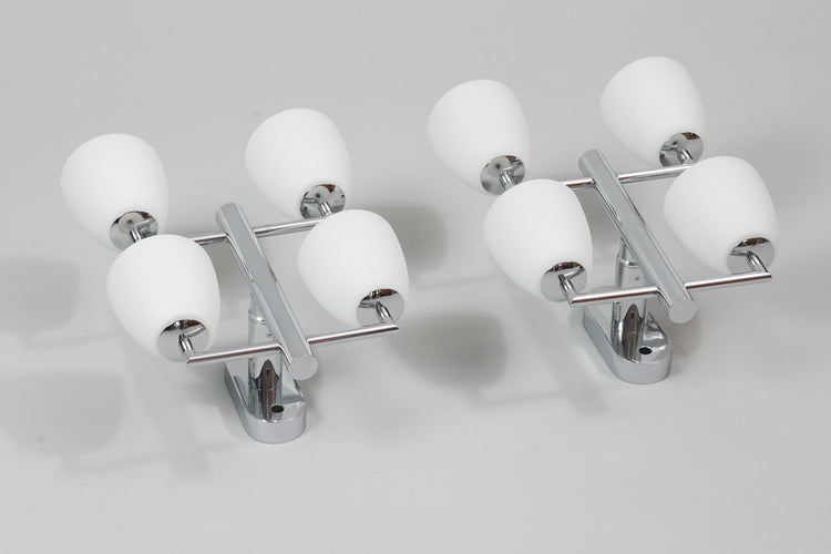 Two identical wall lamps with four white frosted glass domes and chromed metal frame.