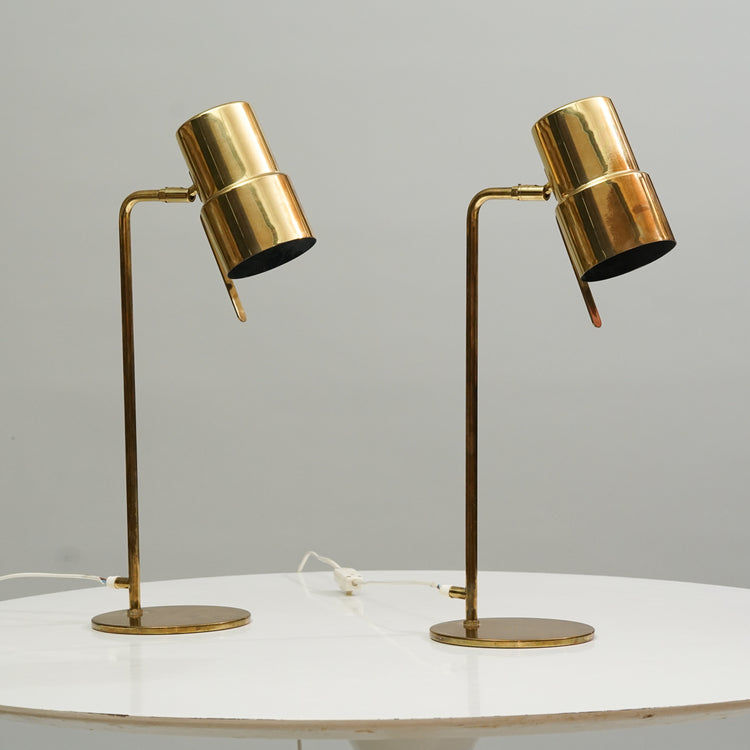 Two identical lamps. The lamp is made of brass, with a thin leg and a cylinder shade.