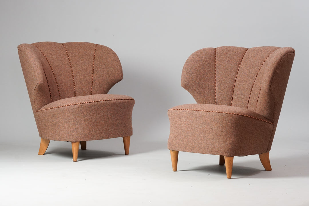 Two identical wingback chairs that are upholstered in brown fabric. Frames of the chairs are birch. 