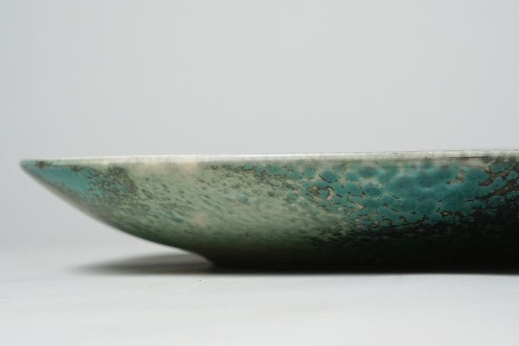 Plate with unique black and turquoise design. 