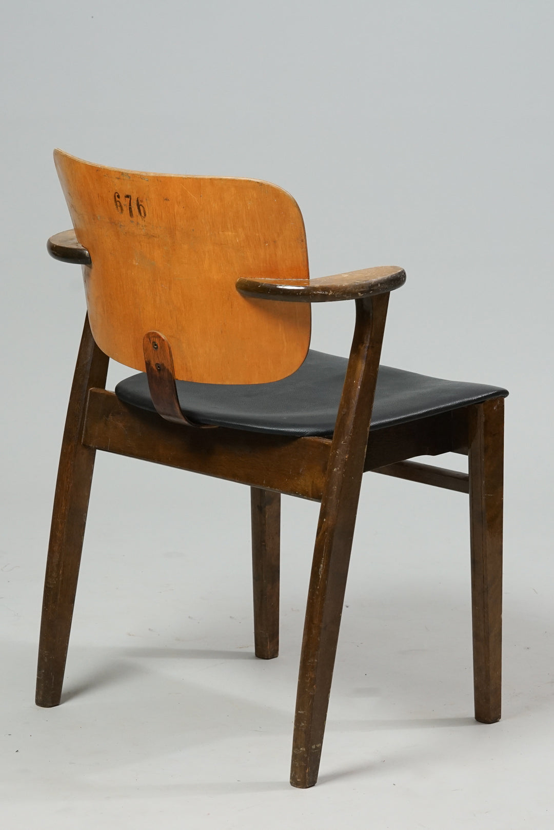 Birch frame chair with a leather seat. The legs and armrests of the chair are dark in color.