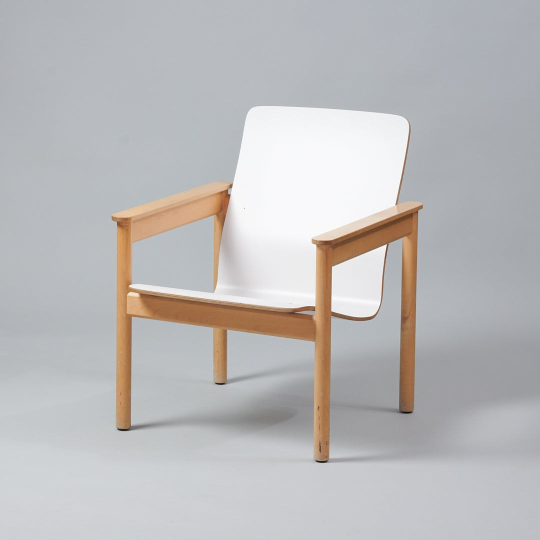 Birch frame armchair with white seat and backrest.