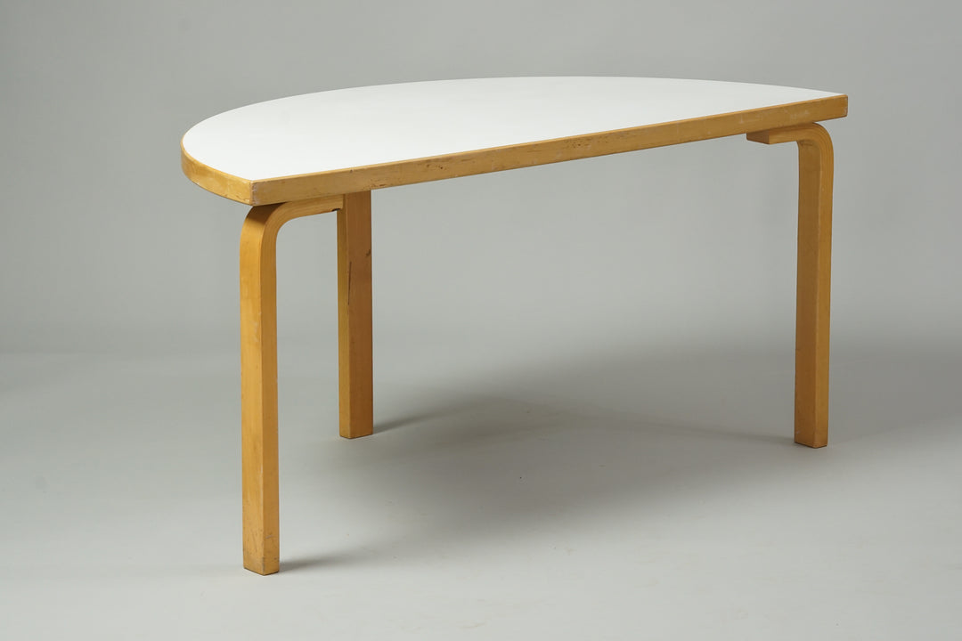 Half-circle birch table with white linoleum top.