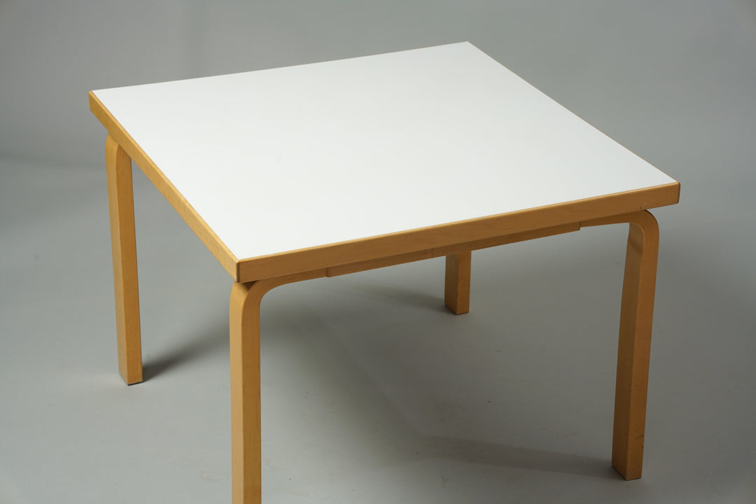 Square coffee table made of birch with a white linoleum top.