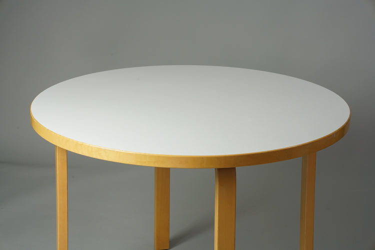 Round birch table with a linoleum top.