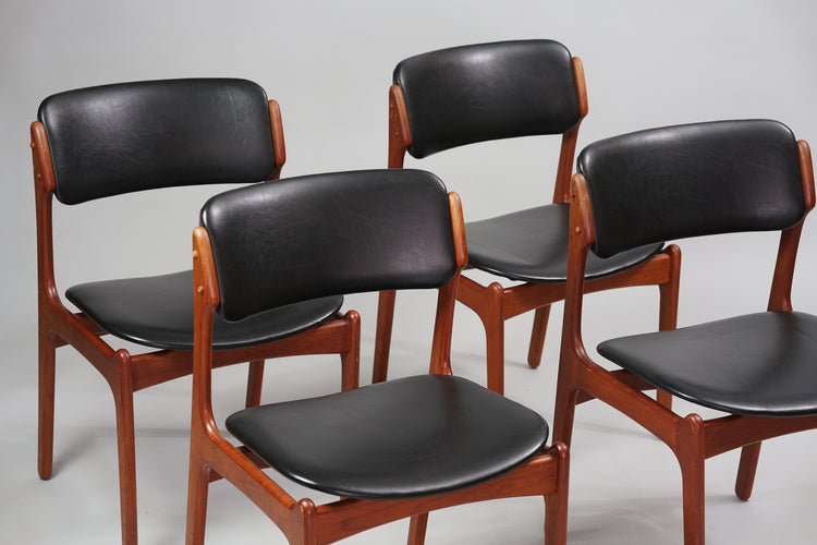 Four similar teak chairs, with seats and backrests made of faux leather.