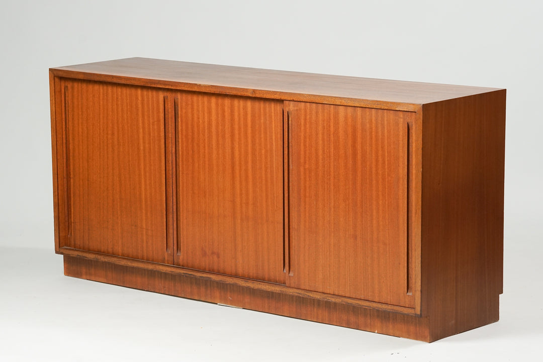Mahogany sideboard with three sliding doors and shelves. In the middle it has three drawers.