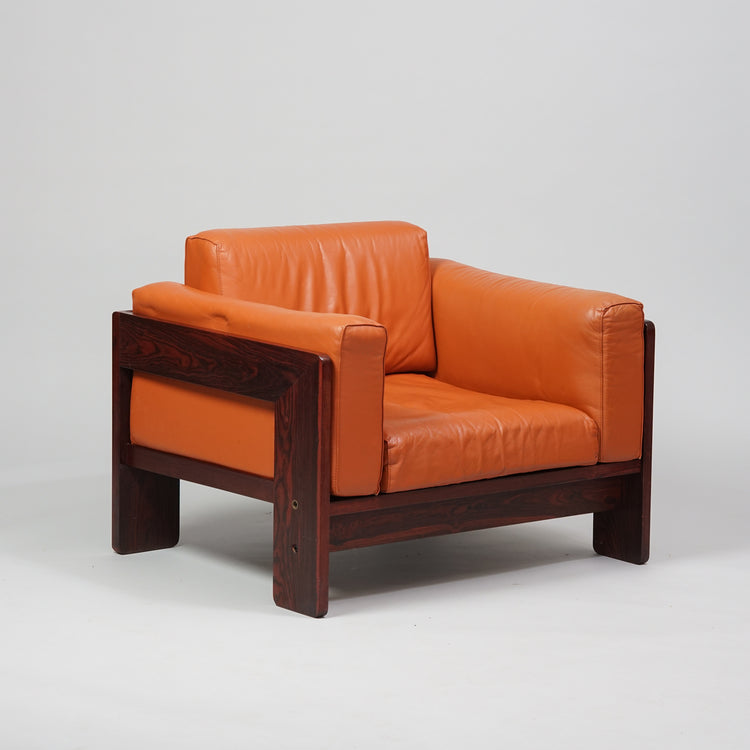 Sturdy armchair. Rosewood frame, cognac colored seating.