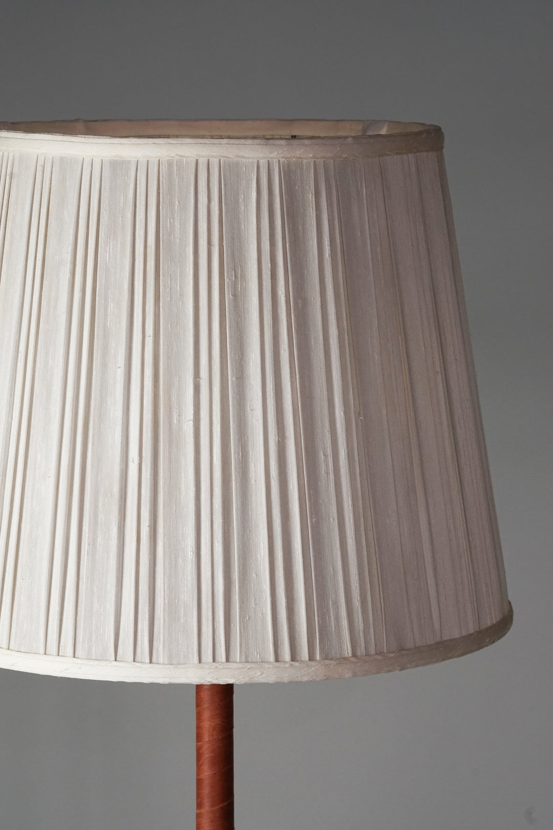 Lamp with off-white silk shade,  brass leg with brown leather detailing.