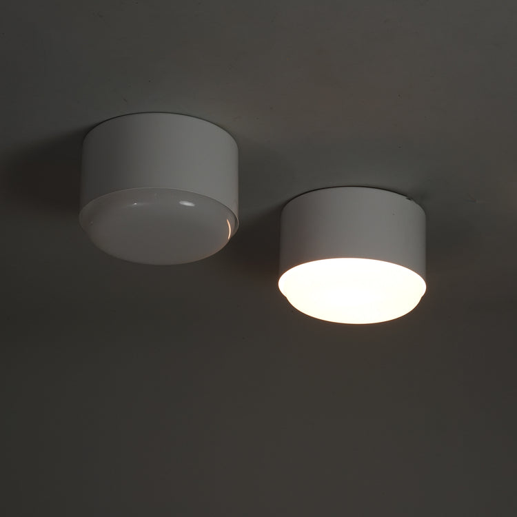 Two identical white ceiling lamps. The frame of the lamp is metal and the dome is acrylic. 