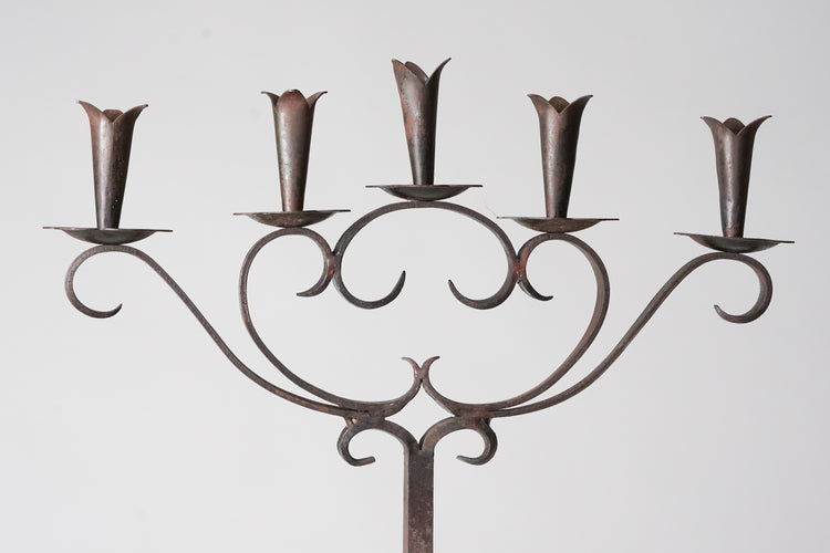 Decorated wrought iron candelabra with five spots for candles.