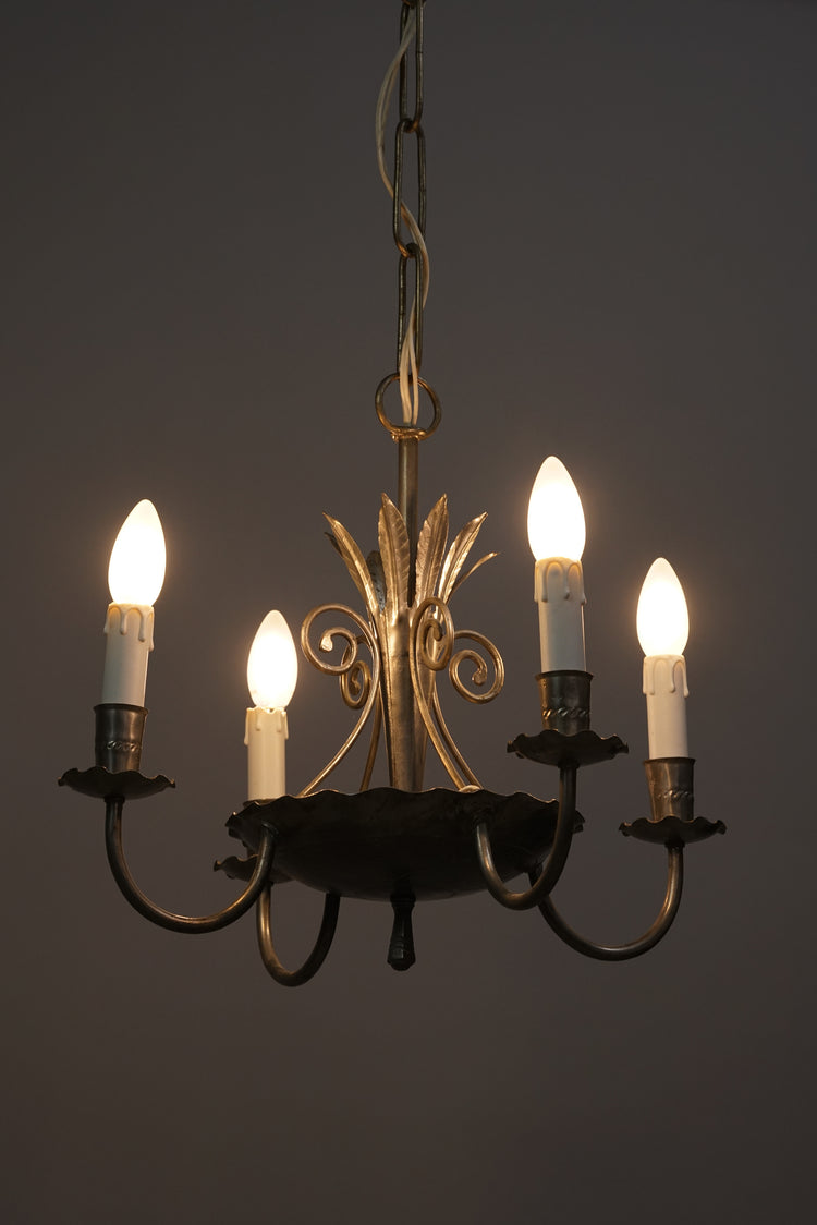 Detailed wrought iron ceiling lamp. Has four holders for lamps or candles.