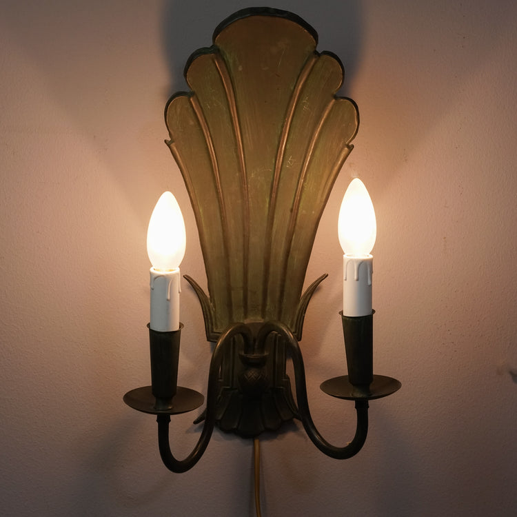 Green decorative iron wall sconce with two spots for either a candle or lamp. 