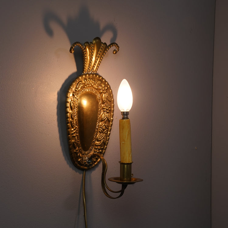 Brass wall sconce in a shape of a strawberry. Sconce has a fruit inspired decoration and spot for one candle. 