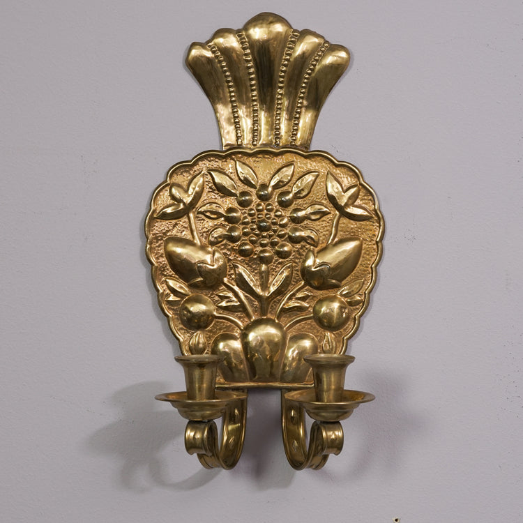 Brass wall sconce shaped like a raspberry with flower decoration and two holders.  